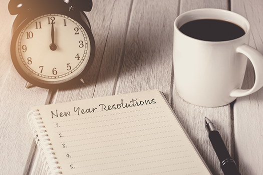 Notebook with New Years Resolutions List and Coffee Mug